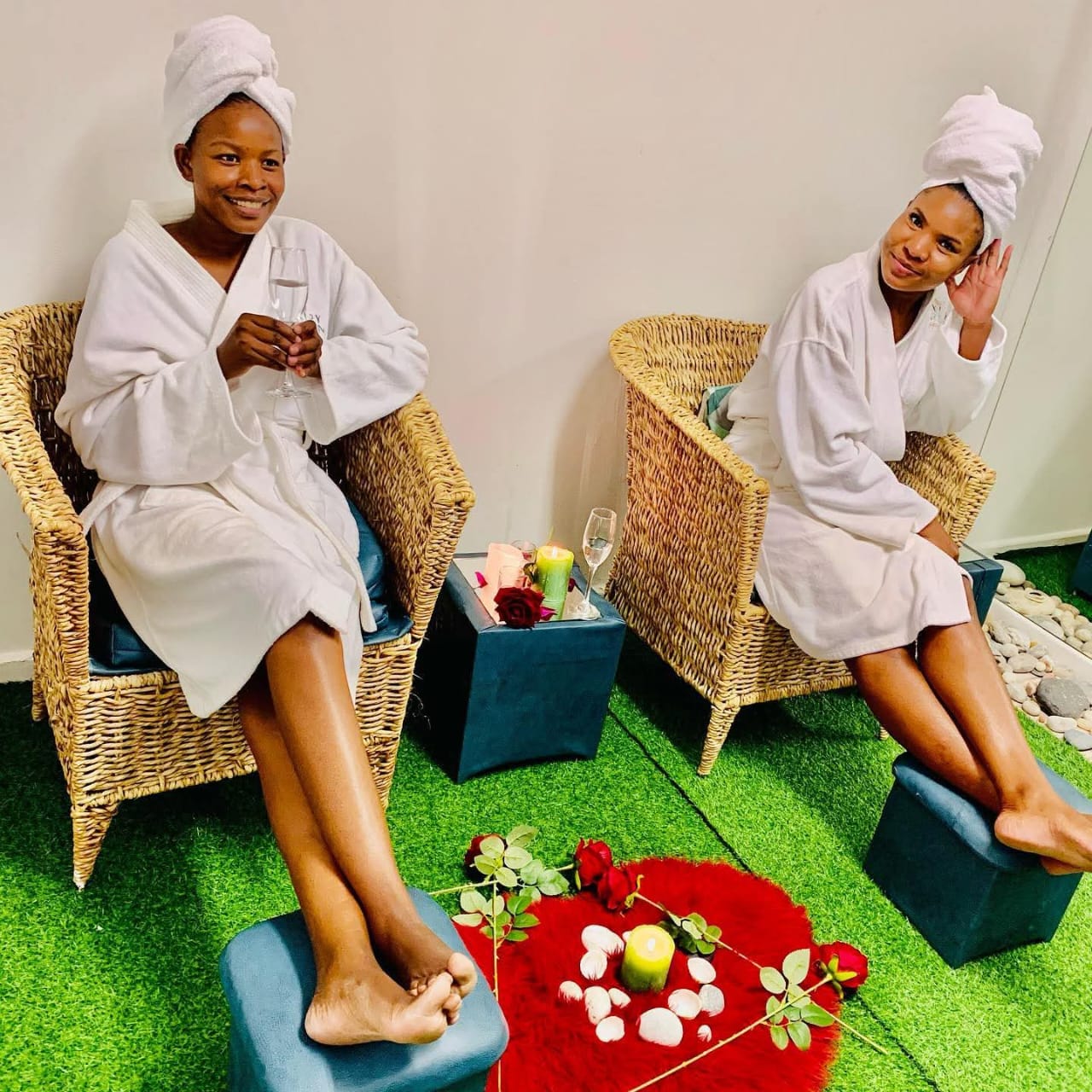 Two guests in robes enjoying a spa date with candles and roses